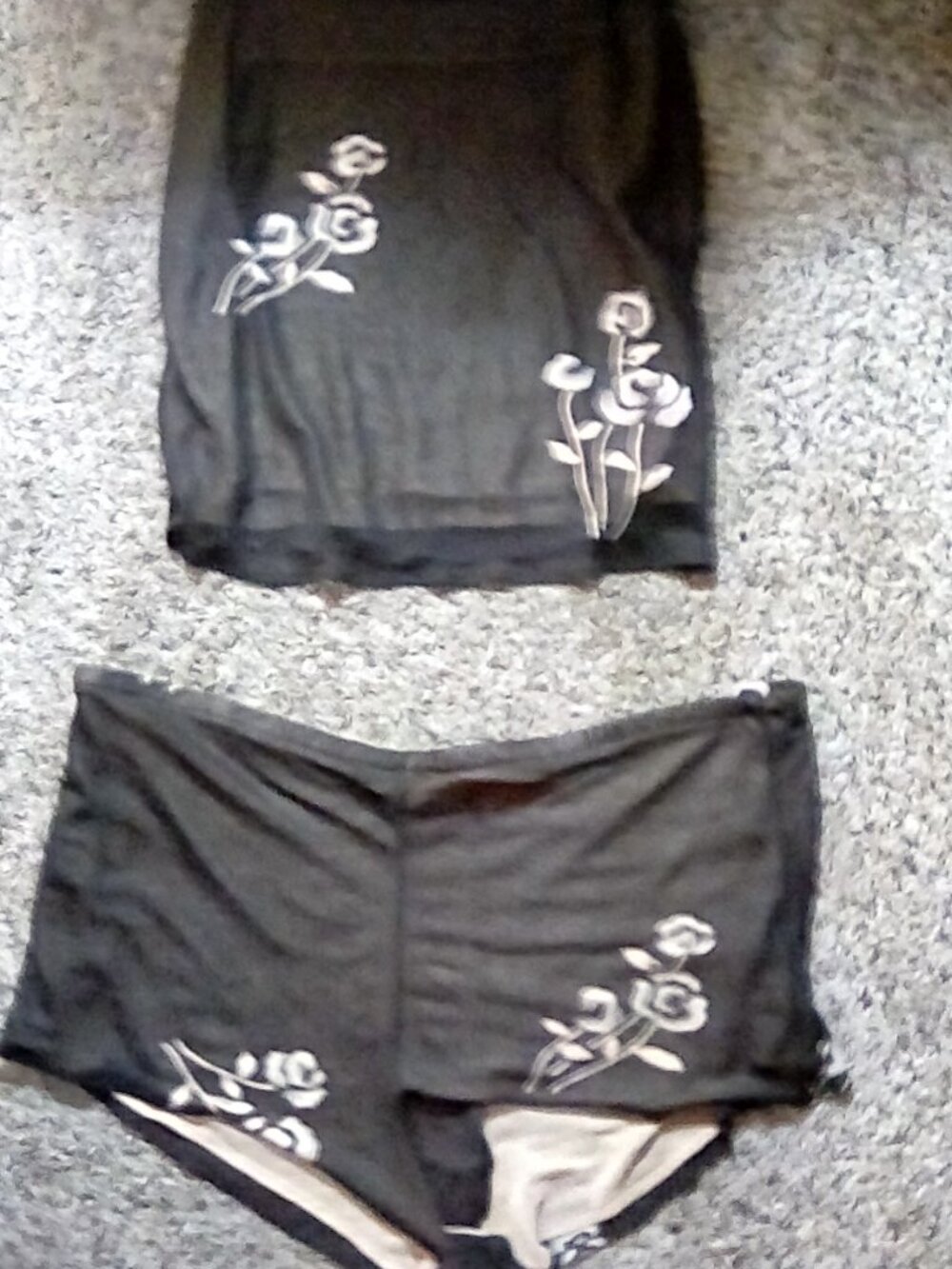 Black almost sheet pajama too and bottom, light purple tank top, pink shirt